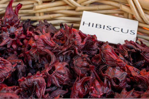 Dried whole hibiscus flowers with sign.