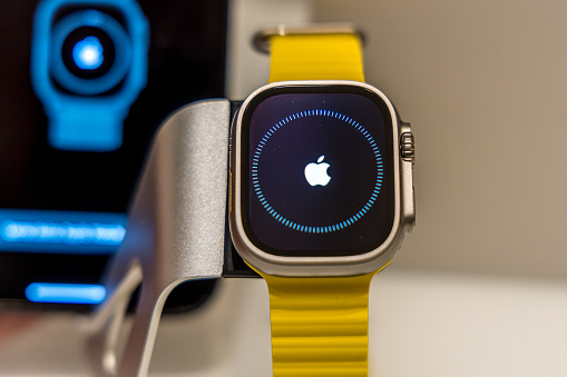 Frankfurt - Main, Germany - September 23rd 2022: A german photographer bought the new Apple Watch Ultra with the yellow Ocean band. Initiated the watch by sending the code and pairing it with the iPhone 13 Pro Max and tried its new functions at home.