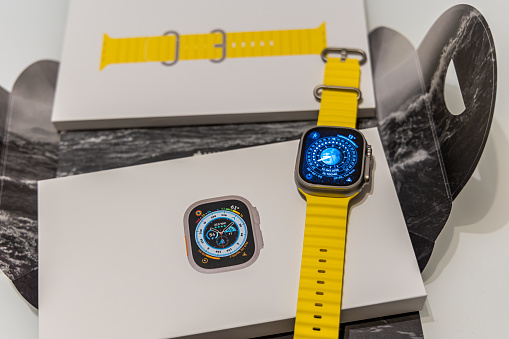 Frankfurt - Main, Germany - September 23rd 2022: A german photographer bought the new Apple Watch Ultra with the yellow Ocean band. Unboxed the watch and looked at the packing which fits to the topic of the band. In this case diving, divided in the watch itself and the band.
