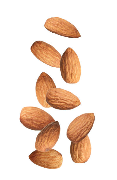 istock Many tasty almonds falling on white background 1433806385