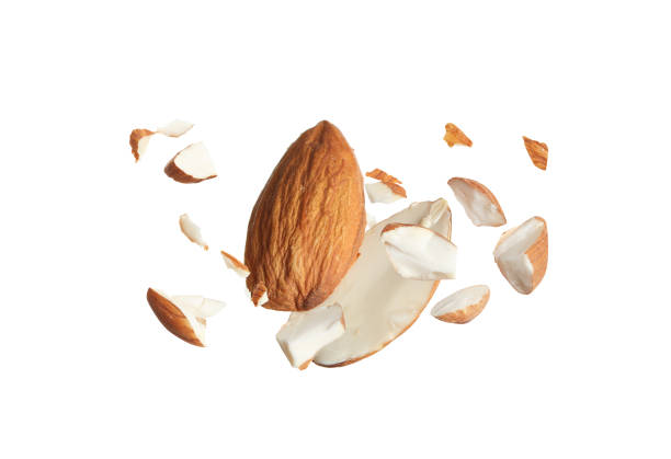 istock Pieces of tasty almonds falling on white background 1433806399