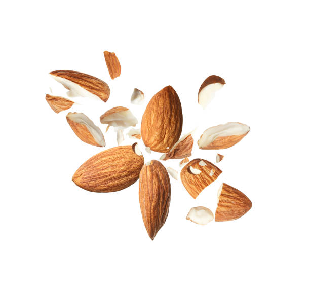istock Pieces of tasty almonds falling on white background 1433806401