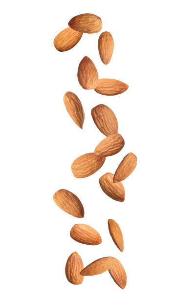 istock Many tasty almonds falling on white background 1433806408