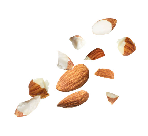 istock Pieces of tasty almonds falling on white background 1433806416