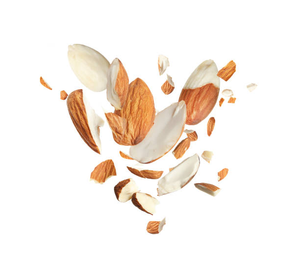 istock Pieces of tasty almonds falling on white background 1433806451