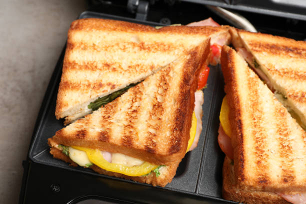 istock Modern grill maker with tasty sandwiches, closeup view 1433806819