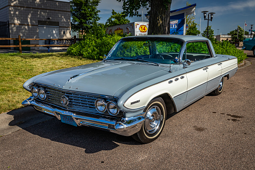 Falcon Heights, MN - June 19, 2022: High perspective front corner view of a 1961 Buick Invicta Sport Sedan at a local car show.