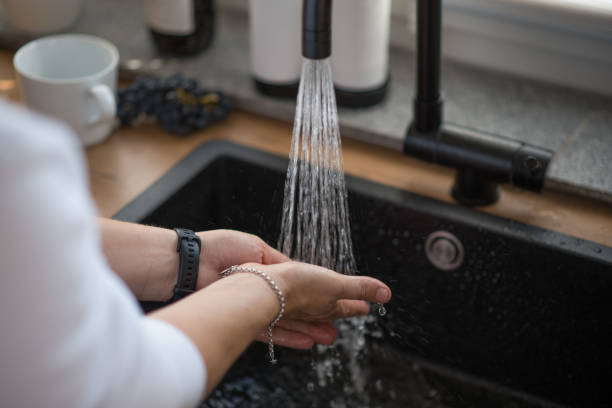 istock a woman washes her hands 1433811025