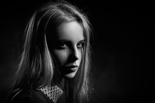 Female portrait of young woman at the backstage of fashion week show. Lifestyle with people, black and white photography