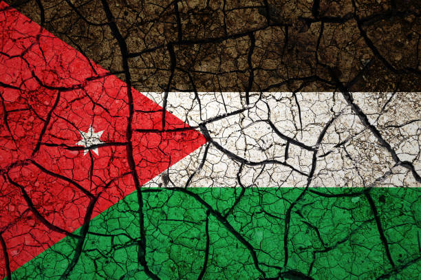 istock Dry soil pattern on the flag of Jordan. 1433813075