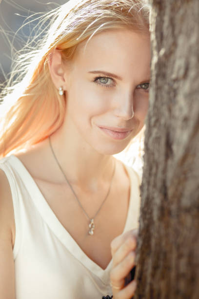Blonde hair woman in city park