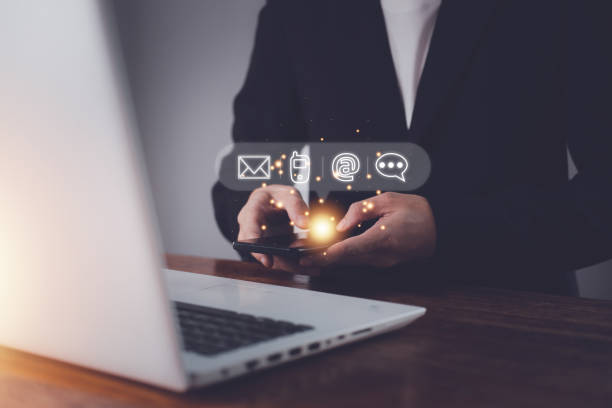 istock Businessman using a smartphone and notebook (laptop). Contact us or Customer support hotline people connect (message, call, email, chat) 1433815117