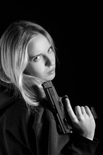 istock girl with gun 1433816504