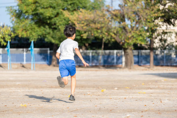 Japanese elementary school students running in the school playground