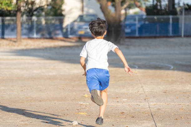 Japanese elementary school students running in the school playground