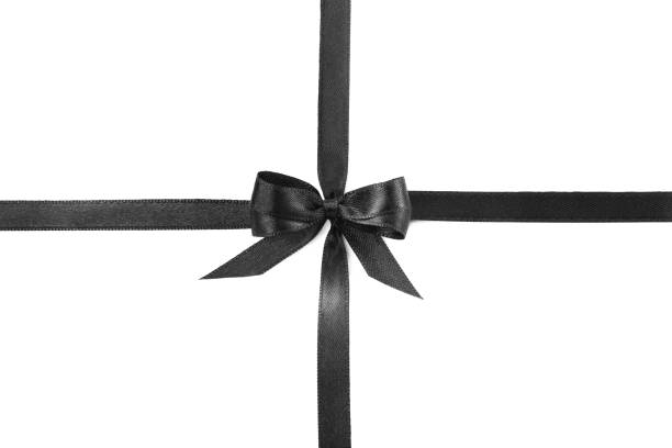 istock Elegant black ribbon with bow isolated on white, top view 1433820604