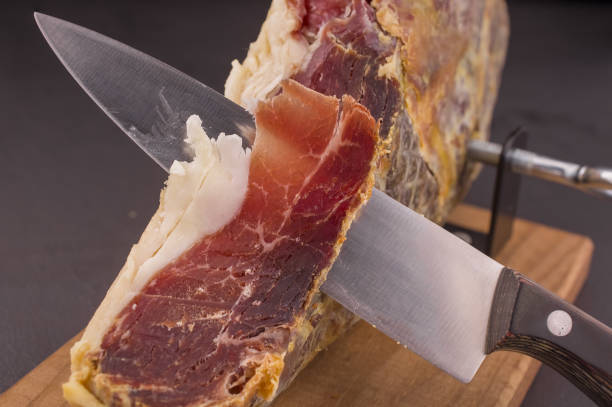 istock Serrano ham leg shoulder on its wooden base ready to be cut 1433823384
