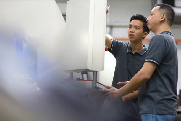 istock Young engineer and foreman working in factory. 1433823457