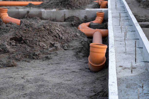 istock New Installed pipework system. Sewer Line developed and mounted on the construction site. New Orange PVC plastic Drainage pipe Tube 1433824025