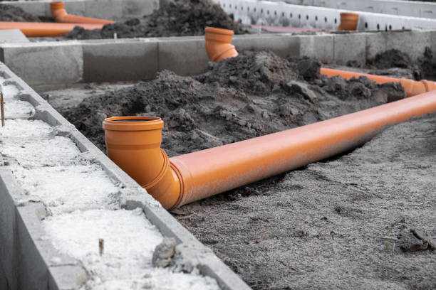 istock New Installed pipework system. Sewer Line developed and mounted on the construction site. New Orange PVC plastic Drainage pipe Tube 1433824097