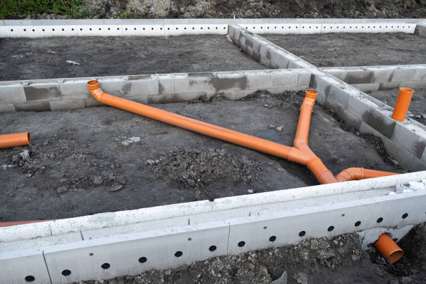 istock New Installed pipework system. Sewer Line developed and mounted on the construction site. New Orange PVC plastic Drainage pipe Tube 1433824165