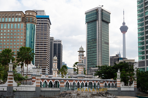 Masjid Jamek Mosque against the financial district of Kuala Lumpur at Klang River, Kuala Lumpur, Malaysia.