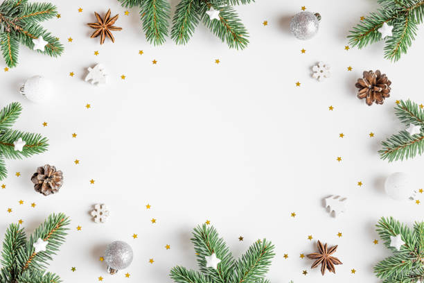 istock Christmas composition. Frame made of fir tree, festive silver decorations on white background. Flat lay. Minimal layout 1433828635