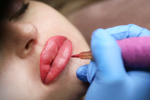 Young woman on a permanent lips make-up treatment. About 25 years old, Caucasian female.