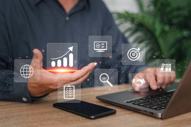 istock Business development and management Executives looking at virtual screens, Businessman use laptops in business work, business graph icon Goal setting in hand for effective management 1433833426