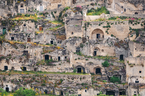 Matera (Basilicata, Italy) is located on a canyon, which defines Matera’s landscape and architecture. Inhabited since the Paleolithic era, established by the Romans in the 3rd century BC, the town is famous for its cave dwellings. The Sassi di Matera is the ancient town of houses carved into the rock. People lived here until the 1950s, but then they were moved because the place needed restoration. Today pubs, restaurants and hotels are found in this location.