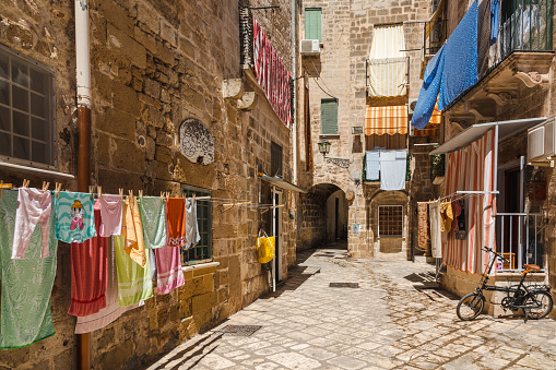 The old, historic centre of Tarento in southern Italy. Narrow streets with laundry hanging outside in numerous places