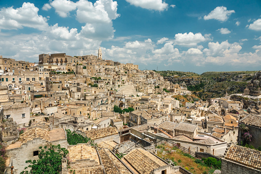 The stunning maze of alleys, stairs and stone houses in the old town of Matera, in southern Italy, known worldwide as the 'Sassi di Matera' (Matera's Stones). The ancient city of Matera, in the region of Basilicata, is one of the oldest urban settlements in the world, with a human presence that dates back to more than 9,000 years ago, in the Paleolithic period. The Matera settlement stands on two rocky limestone hills called 'Sassi' (Sasso Caveoso and Sasso Barisano), where the first human communities lived in the caves of the area. The rock cavities have served over the centuries as a primitive dwelling, foundations and material for the construction of houses, roads and beautiful churches, making Matera a unique city in the world. In 1993 the Sassi of Matera were declared a World Heritage Site by Unesco. Image in High Definition format.