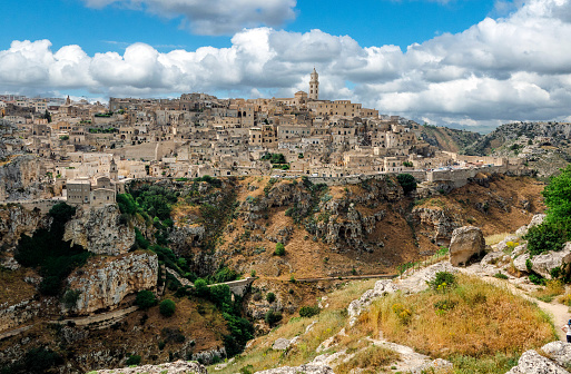 Matera (Basilicata, Italy) is located on a canyon, which defines Matera’s landscape and architecture. Inhabited since the Paleolithic era, established by the Romans in the 3rd century BC, the town is famous for its cave dwellings. The Sassi di Matera is the ancient town of houses carved into the rock. People lived here until the 1950s, but then they were moved because the place needed restoration. Today pubs, restaurants and hotels are found in this location.