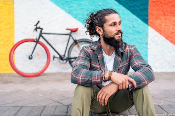 istock Hipster Man Sitting in the Street 1433834626