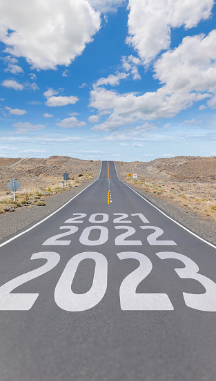 Highway with new year 2023 painted on asphalt after the passing years of 2021 and 22