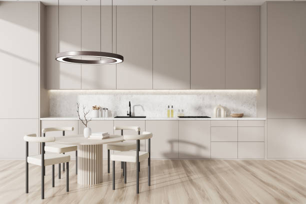 istock Light kitchen interior with seats and eating table on wooden floor 1433837966