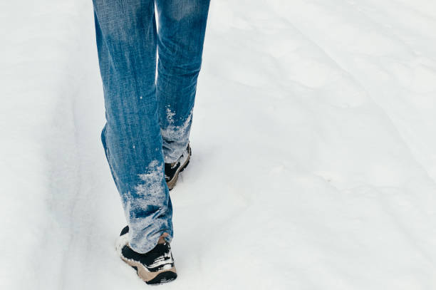 istock Back view of man walking in snow 1433840838