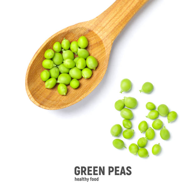 istock Fresh green peas in wooden spoon, isolated on white background 1433841296