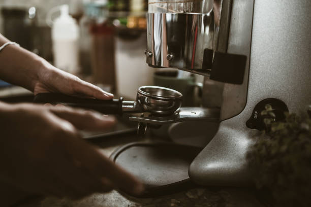istock barista use bottomless filter with grinder machine at coffee shop. coffee maker concept. 1433843080
