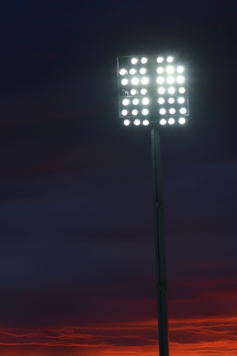 Stadium lights just before sunset.