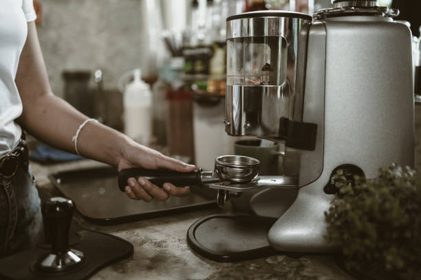 istock barista use bottomless filter with grinder machine at coffee shop. coffee maker concept. 1433847667