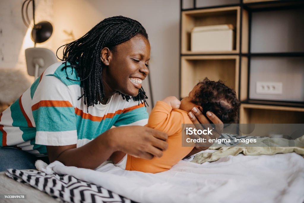 Mother and baby love Shot of a young woman playing with her adorable baby  on the bed at home Baby - Human Age Stock Photo