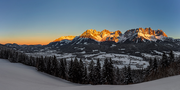 Sunset light with alpen glow on Tetons Tetons mountains rugged with moon rising