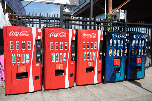 Brooklyn, NY, USA - June 5, 2022: A row of Coca-Cola and Dasani vending machines in Coney Island.