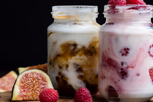 Milk yogurt with raspberries, layered yogurt with raspberry flavor and fresh berries