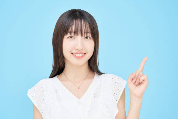 istock A young woman making an introduction gesture 1433850594