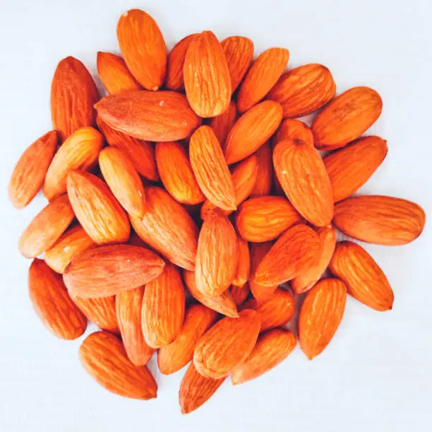 Almond nuts or Badam or Lauz or amêndoa or badem or mandle  ořechor or mandel or amandel, almendra, manteli, or amande or mandorla or Badem or qua hanh Prunus dulcis  in white background