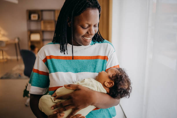 istock Loving mom holding her baby 1433852050