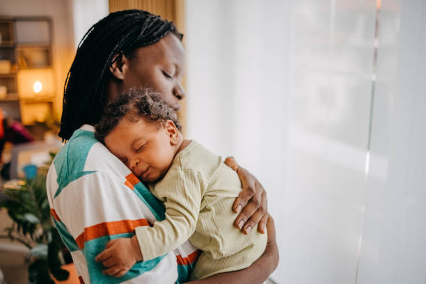 istock Loving mom holding her baby 1433852202