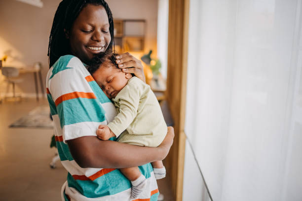 istock Loving mom holding her baby 1433852260